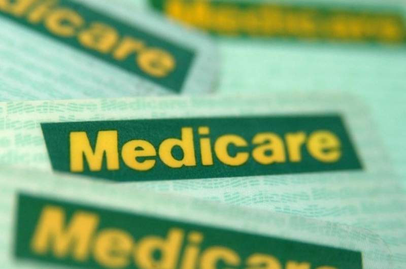 Multiple Australian Medicare cards in a pile.