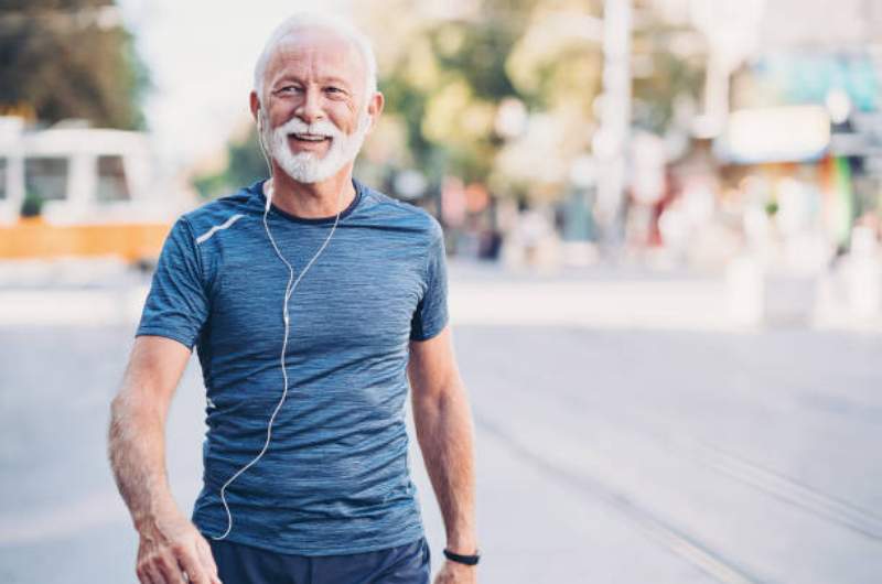 Healthy senior aged individual smiling and walking to Over 75 Health Assessments available at Narangba Station Medical Centre.