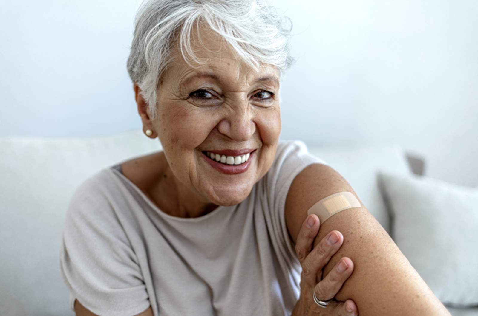 Elderly individual showing plaster on arm after receiving Shingles vaccination at Narangba Station Medical Centre.