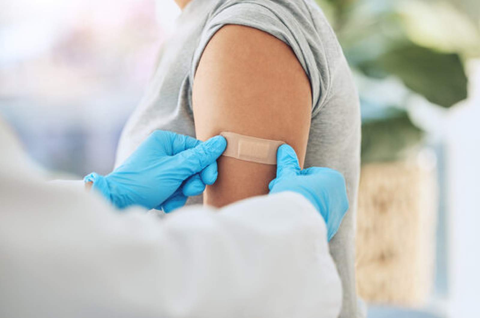 Individual's arm with plaster after receiving influenza (flu) vaccination at Narangba Station Medical Centre.