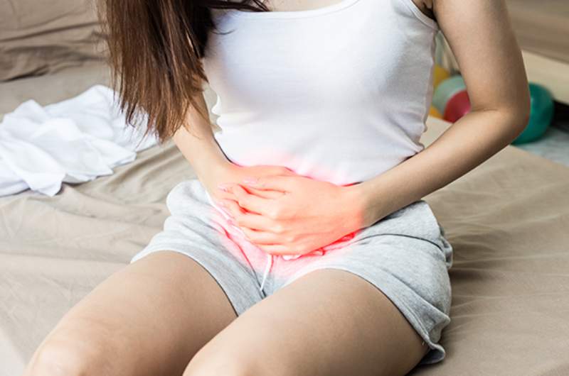 Individual-clutching-lower-stomach-in-pain-suffering-from-urinary-tract-infection Individual clutching lower stomach in pain suffering from urinary tract infection