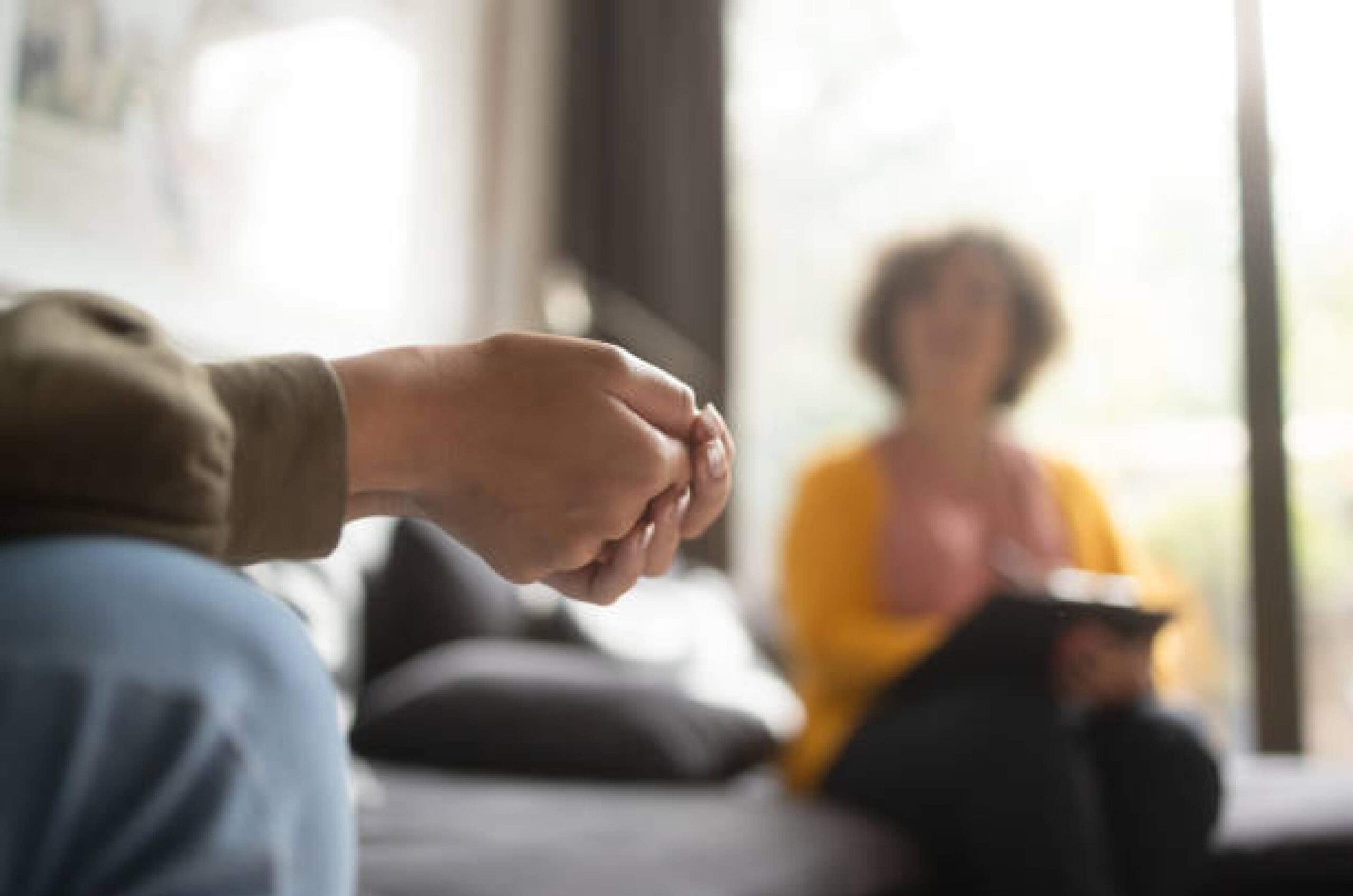 Psychologist-in-consultation-with-patient-in-safe-environment Psychologist in consultation with patient creating safe and open environment.