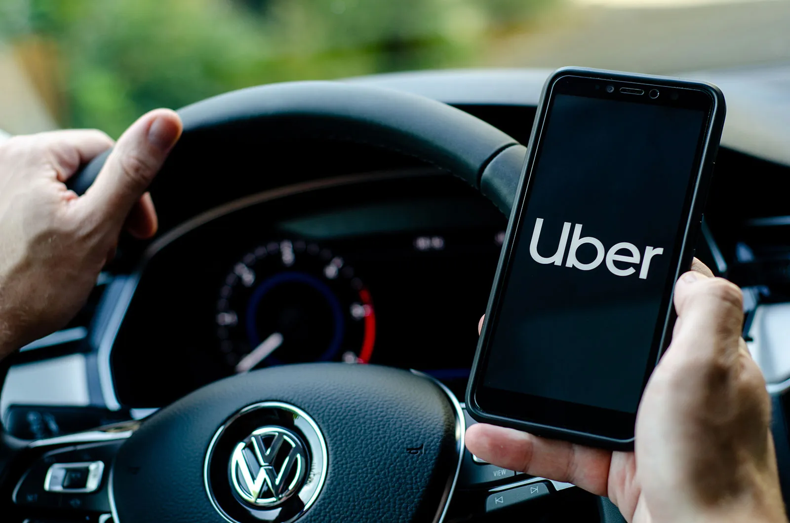 An Uber driver holds his smartphone with the Uber app open after completing an Uber Driver Medical Assessment at Narangba Station Medical Centre.