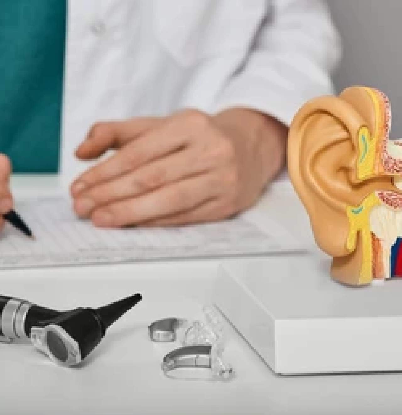 Audiologist at Narangba Station Medical Centre with hearing health tools laid out.